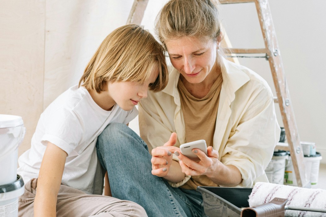 mother and son using smartphone together